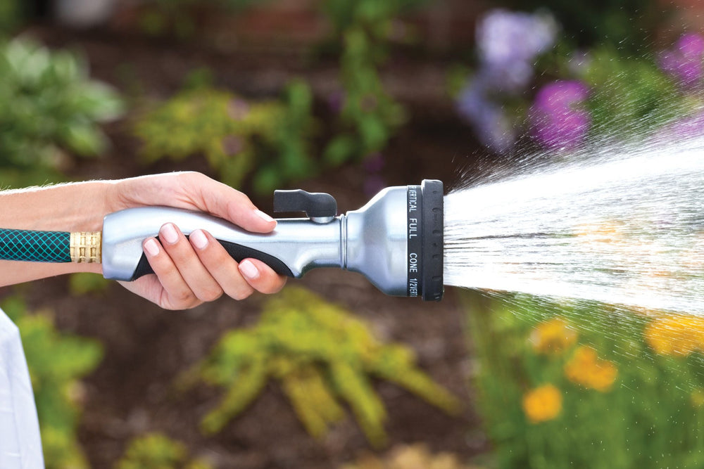 Metal ten pattern turret torch hose spray nozzle, emitting a full spray  of water. 