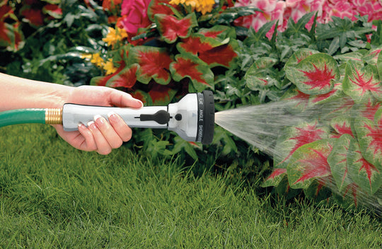 Metal ten pattern turret torch hose spray nozzle, emitting a cone pattern spray of water. 