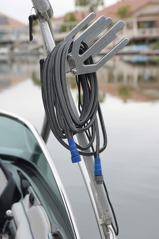 Gray Yachtsman fifty-foot expandable hose with blue female and male couplings, hanging off the side of a boat. 