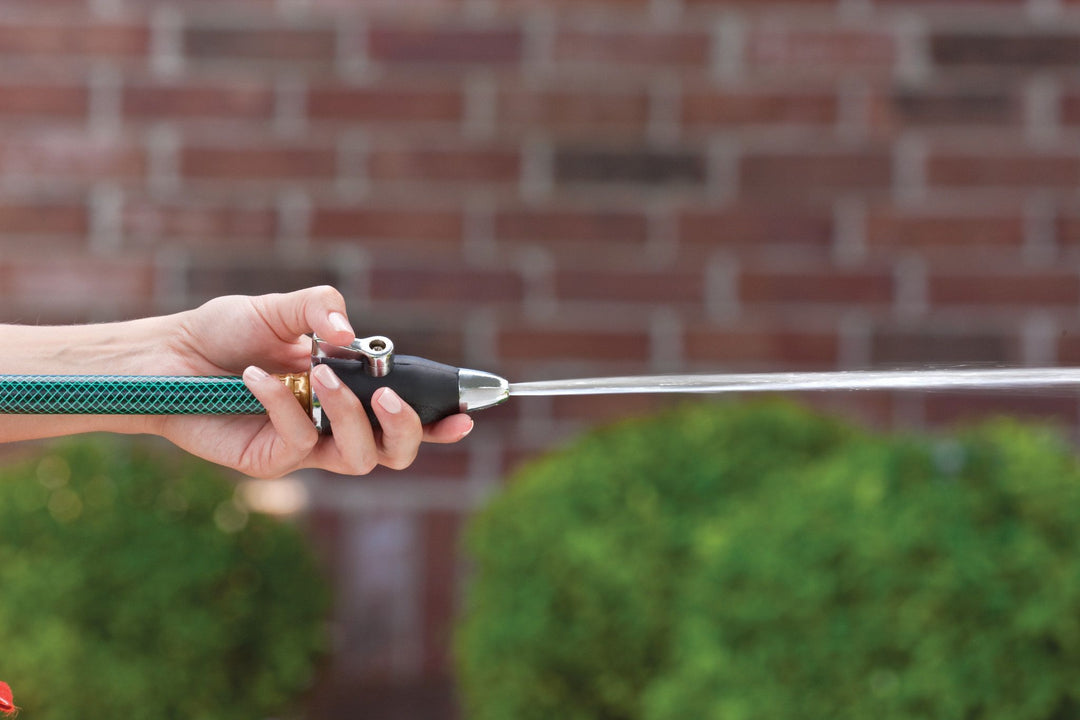 Zinc sweeper nozzle with shut off lever and rubber non-slip grip, emitting a stream of water.